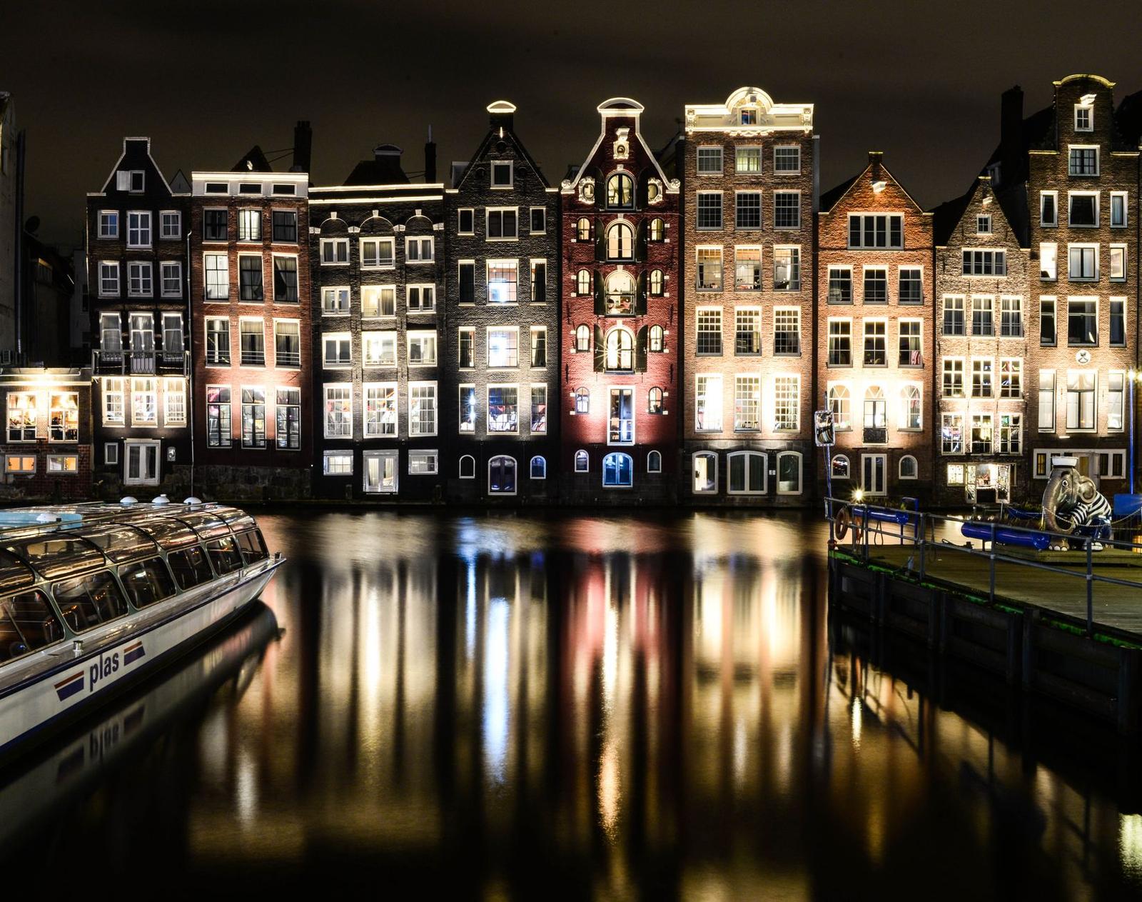 Illuminated Tenements by Canal in Amsterdam at Night